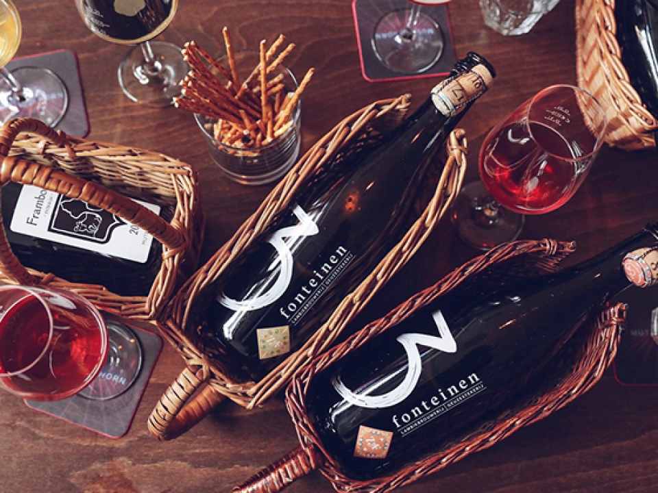 A table with bottle of beer and glasses